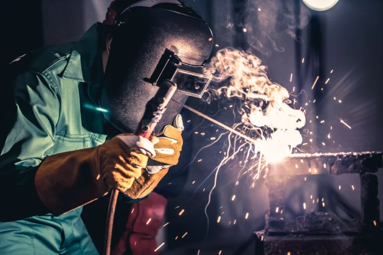 a man wearing a welding mask while welding.